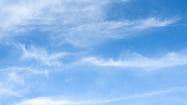 The sky is a vibrant, cloudless blue, while the sun shines brightly, making it appear even more radiant.