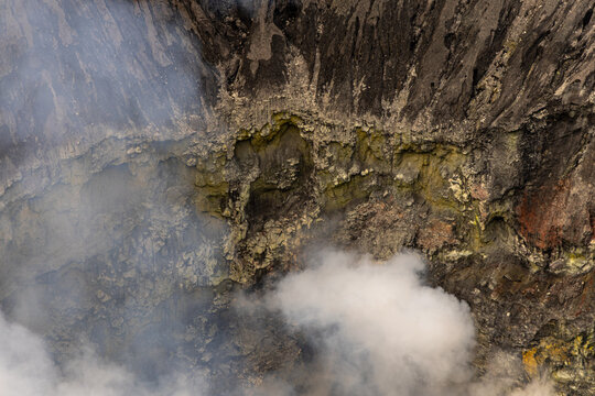 Active Mount Bromo volcano crater with sulfur smoke and volcanic sand sea, Tengger Semeru National Park, East Java, Indonesia.