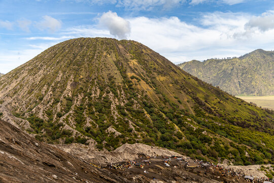 Active Mount Bromo volcano crater with sulfur smoke and volcanic sand sea, Tengger Semeru National Park, East Java, Indonesia.