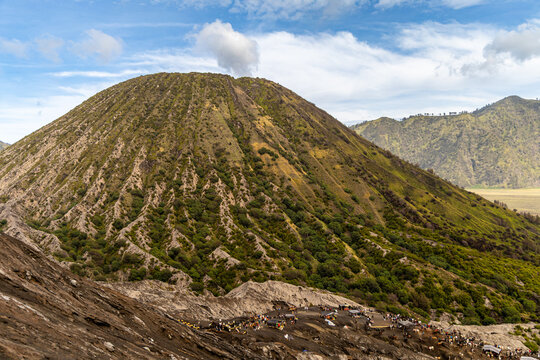 Active Mount Bromo volcano crater with sulfur smoke and volcanic sand sea, Tengger Semeru National Park, East Java, Indonesia.