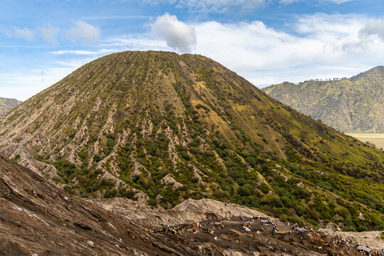 Active Mount Bromo volcano crater with sulfur smoke and volcanic sand sea, Tengger Semeru National Park, East Java, Indonesia.