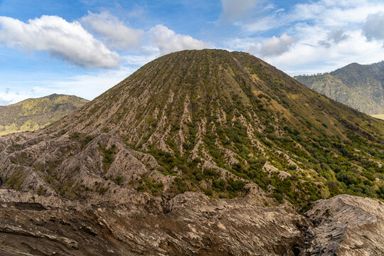Active Mount Bromo volcano crater with sulfur smoke and volcanic sand sea, Tengger Semeru National Park, East Java, Indonesia.