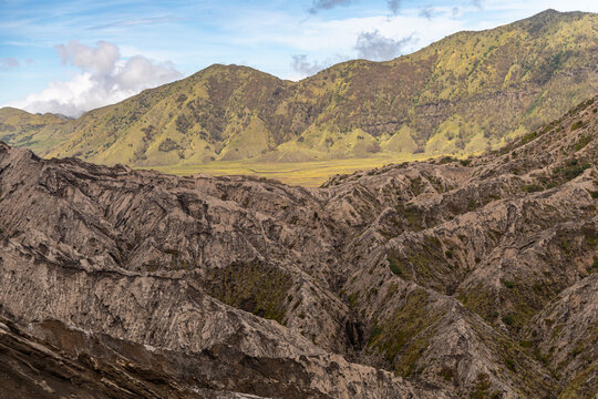 Active Mount Bromo volcano crater with sulfur smoke and volcanic sand sea, Tengger Semeru National Park, East Java, Indonesia.