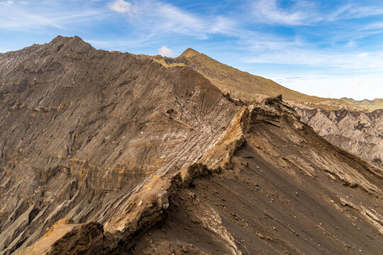 Active Mount Bromo volcano crater with sulfur smoke and volcanic sand sea, Tengger Semeru National Park, East Java, Indonesia.