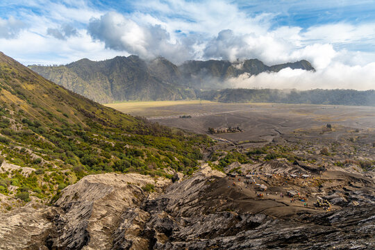 Active Mount Bromo volcano crater with sulfur smoke and volcanic sand sea, Tengger Semeru National Park, East Java, Indonesia.