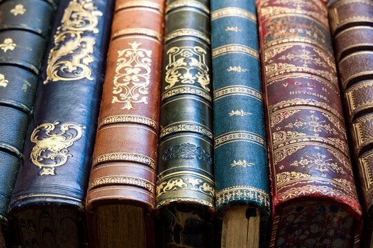 Antique old book with richly decorated cover and ornate spine, showing the history of traditional book bindings and fine leather craftsmanship. Vintage volumes from an old library.