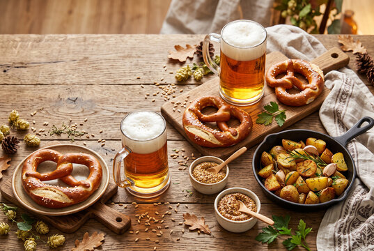 Beer pretzels and roasted potatoes in a skillet with copy space