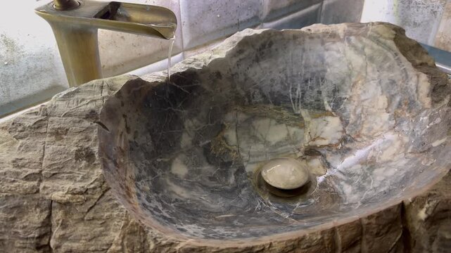 Bathroom sink and running water from the tap
