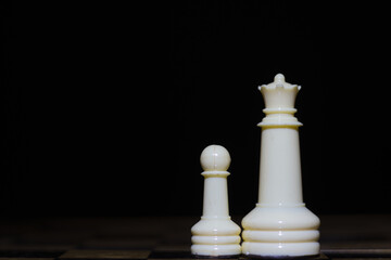 white chess pieces: pawn and queen © Ana Maria