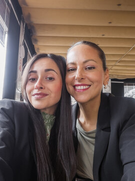 UGC selfie of mother and adult daughter together at cafe
