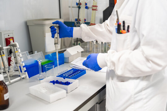Scientist Uses Pipette in Laboratory to Transfer Samples