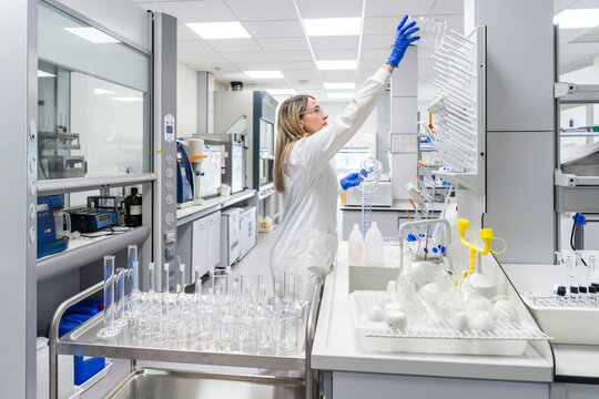 Scientist Organizes Equipment and Conducts Research in Laboratory
