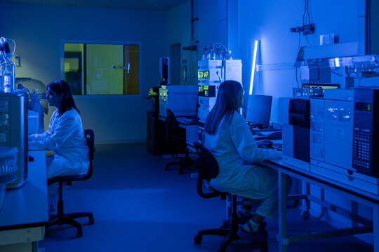 Researchers Work in a Laboratory With Blue Lighting at Night