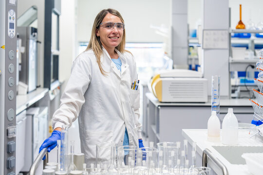 Scientist Working in a Laboratory With Glassware and Equipment