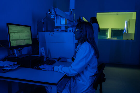 Scientist Works in Lab at Night With Computer and Documents