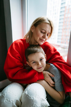 Mother and Son Enjoy a Cozy Moment by the Window