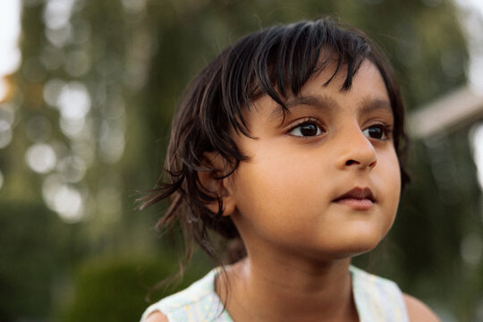 Candid portrait of a thoughtful young girl outdoors