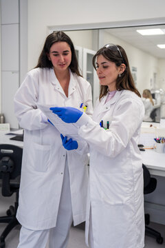 Scientists Discuss Research in Laboratory