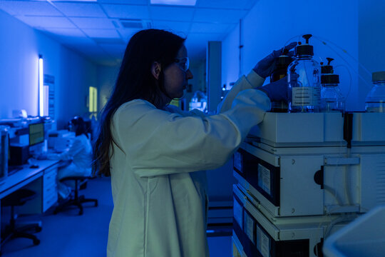Scientist Works in Laboratory With Blue Lighting at Night