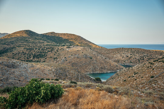 remote mediterranean landscape with dry hills and a quiet bay