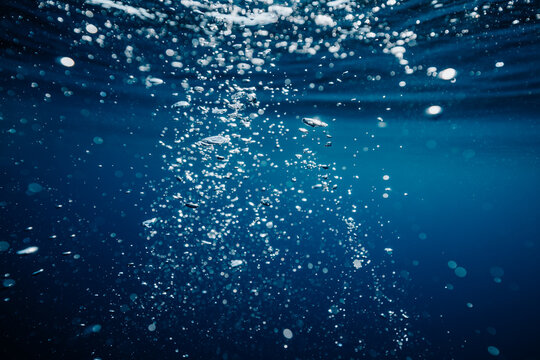 swirling bubbles forming a pattern underwater
