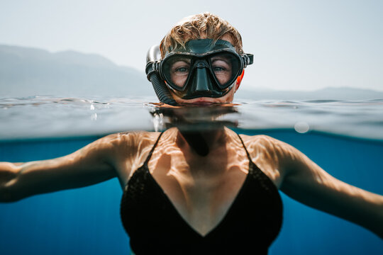 smiling freediver relaxing at the surface between dives