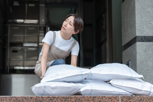 土嚢を積む女性