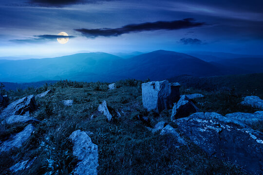 Carpathian mountain landscape in summer at night. scenic view of Transcarpathia region from the mnt. Smooth. alpine blueberry field with rock on the Polonyna Runa hill in full moon light
