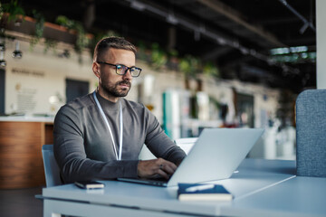 Man working on laptop, focused on business technology
