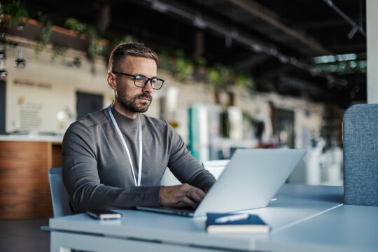 Man working on laptop, focused on business technology