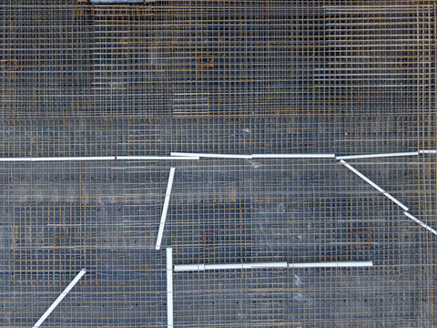Aerial view of a complex rebar grid and white conduit pipes laid out on a construction site in Istanbul, Istanbul, Turkiye.