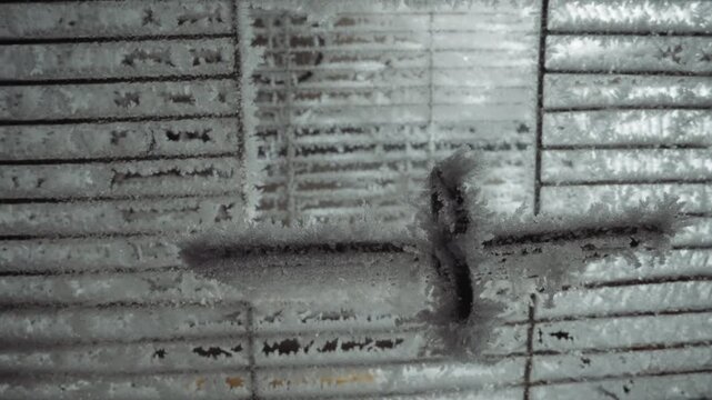 Knotted rope on frozen latch, closeup shows icy crust and corroded metal, emergency seal trace after reactor cold shutdown, gritty monochrome texture captures isolation, endurance and tenuous