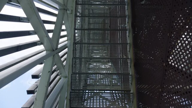 Low-angle view of industrial metal staircase and steel framework