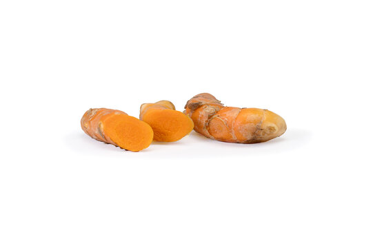 Whole and cut turmeric root clean white background