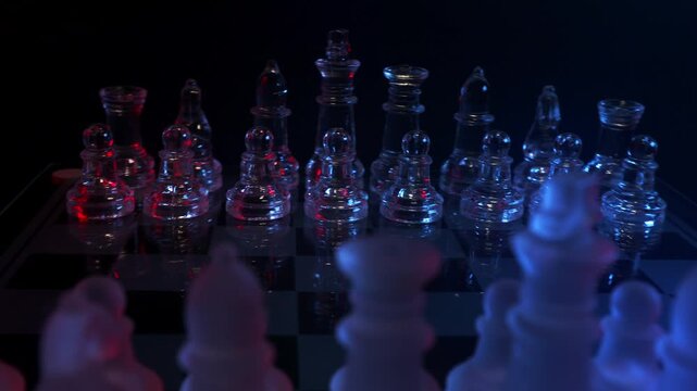 Circular camera movement around a modern glass chess set showcasing dynamic focus and strategic aesthetic, high-angle