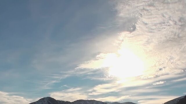 Cold Arctic Waters Rolling Beneath Wide Polar Sky Across the Far North. Snow-covered mountains remain visible beyond the cold open water and the distant polar horizon.