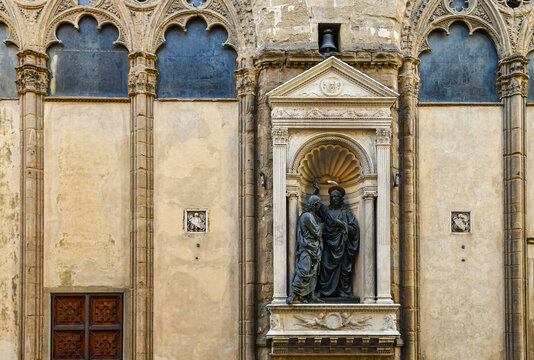 Christ and Saint Thomas bronze statues by Andrea del Verrocchio in the tabernacle facade of Orsanmichele church, Florence, Tuscany, Italy