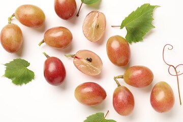 Fototapeta premium Fresh ripe grapes and green leaves on white background, flat lay