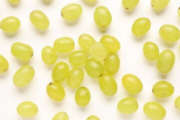 Fototapeta premium Fresh ripe grapes on white background, flat lay