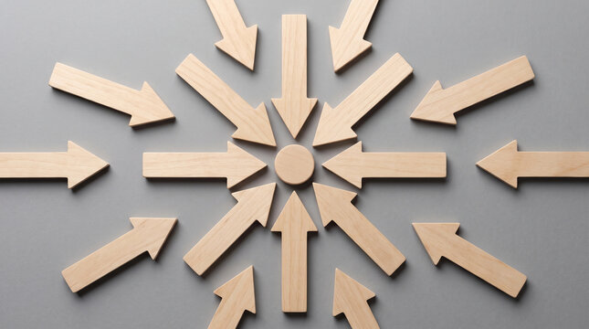 Wooden arrows converging to center concept showing synergy and unity for focused and motivated purpose in minimal business strategy