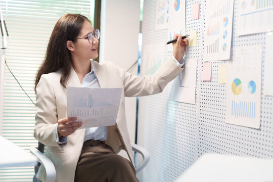 Successful Businesswoman Presenting Business Growth Charts