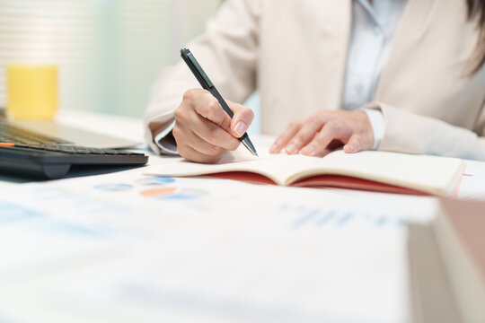 Businesswoman Analyzing Financial Documents and Budget