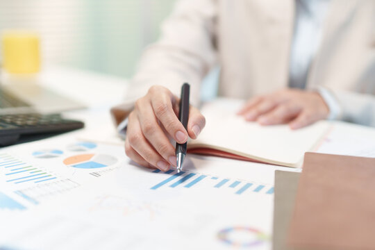 Businesswoman Analyzing Financial Charts and Budget Reports