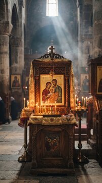 Icon of Jesus Christ, Mary and Joseph displayed on a candlelit altar inside a church. Christian worship and devotion. Sacred art and Catholic faith. Religious heritage and tradition.