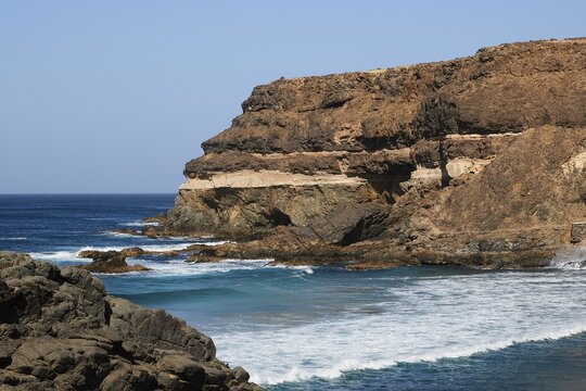 Puertito de los Molinos, rocky coast, rocks, surf, blue cloudless sky, west coast, Fuerteventura, Canary Islands, Spain