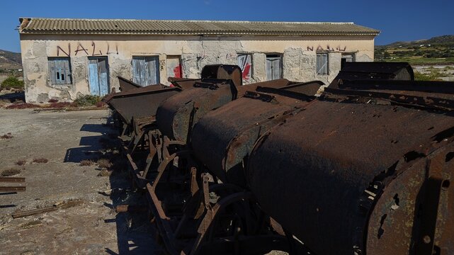 Dilapidated building with rusty machinery and graffiti under blue sky, saltworks, Lost Place, near airport, salt lake, Alykes Milou, Milos, Cyclades, Greek Islands, Greece
