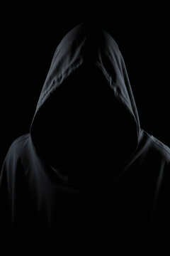faceless figure in dark hood