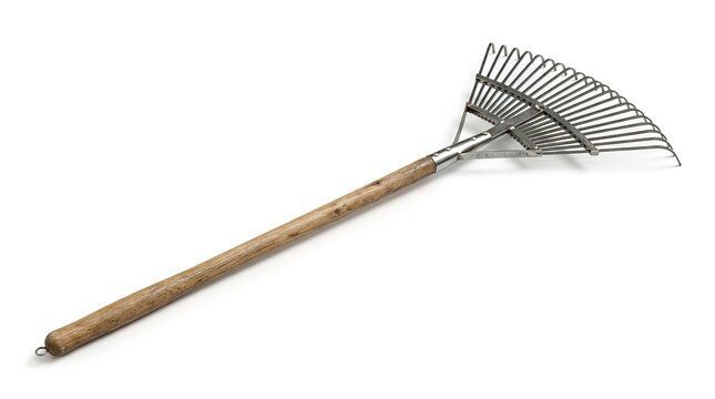 Old garden leaf rake with wooden handle on white background