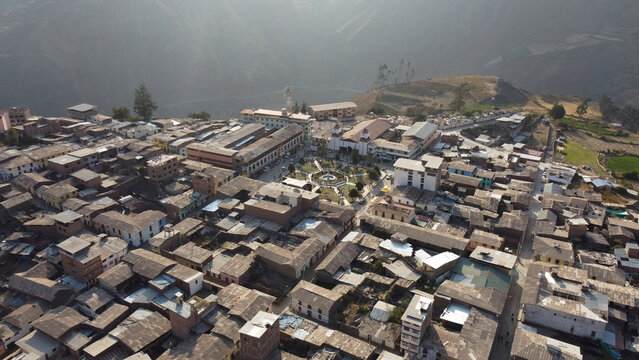 Aerial view of the town of Canta featuring its central plaza, historic church, and dense collection of rooftops nestled within the mountainous landscape of the Andes in Canta, Lima Region, Peru.