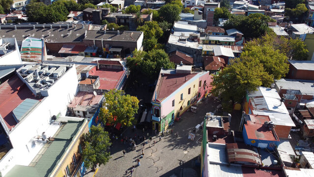 Aerial view of the colorful buildings and cobblestone streets of the Caminito in La Boca with people walking below in Buenos Aires, Buenos Aires, Argentina.